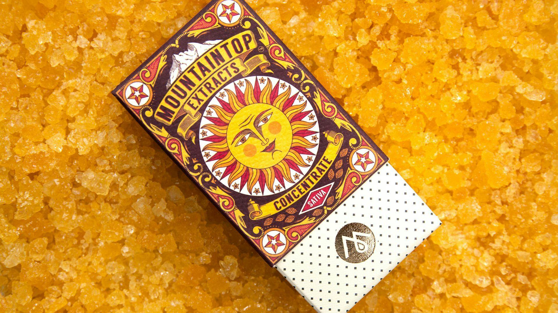 a photo of Mountaintop Extracts cannabis concentrate packaging, resting atop concentrated cannabis caviar.