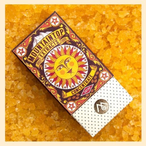 a photo of Mountaintop Extracts cannabis concentrate packaging, resting atop concentrated cannabis caviar.